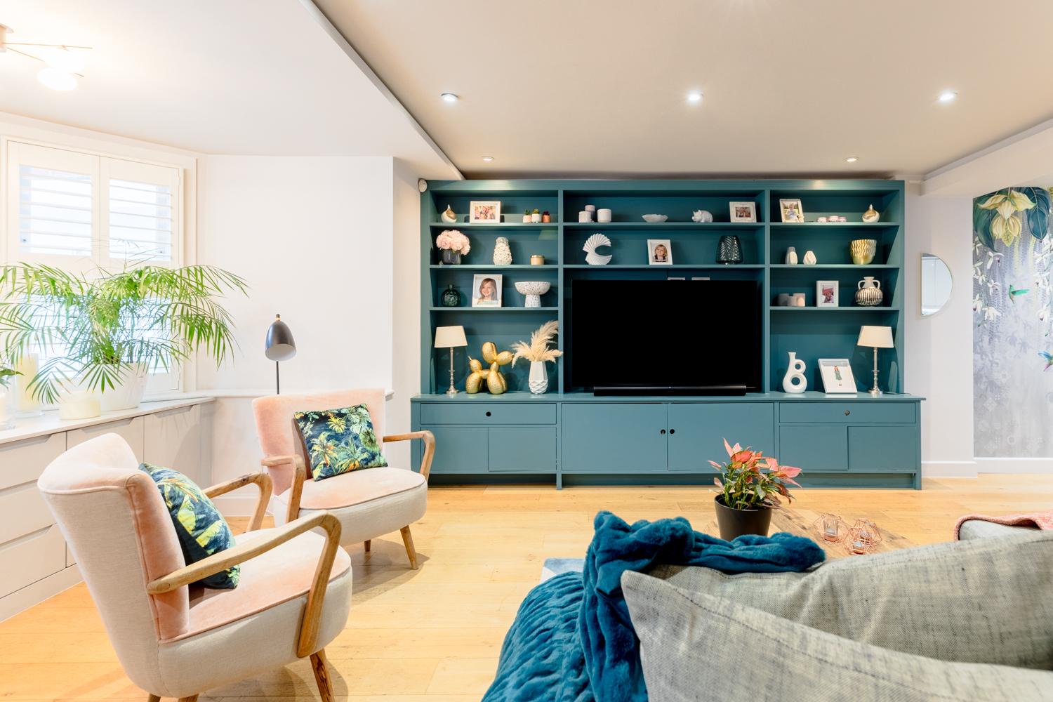 Living room with striking TV media unit in dark green.