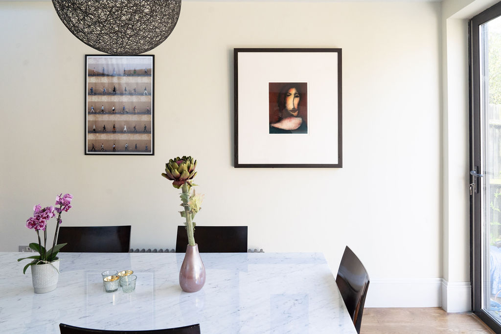 dining table with chairs and wall art