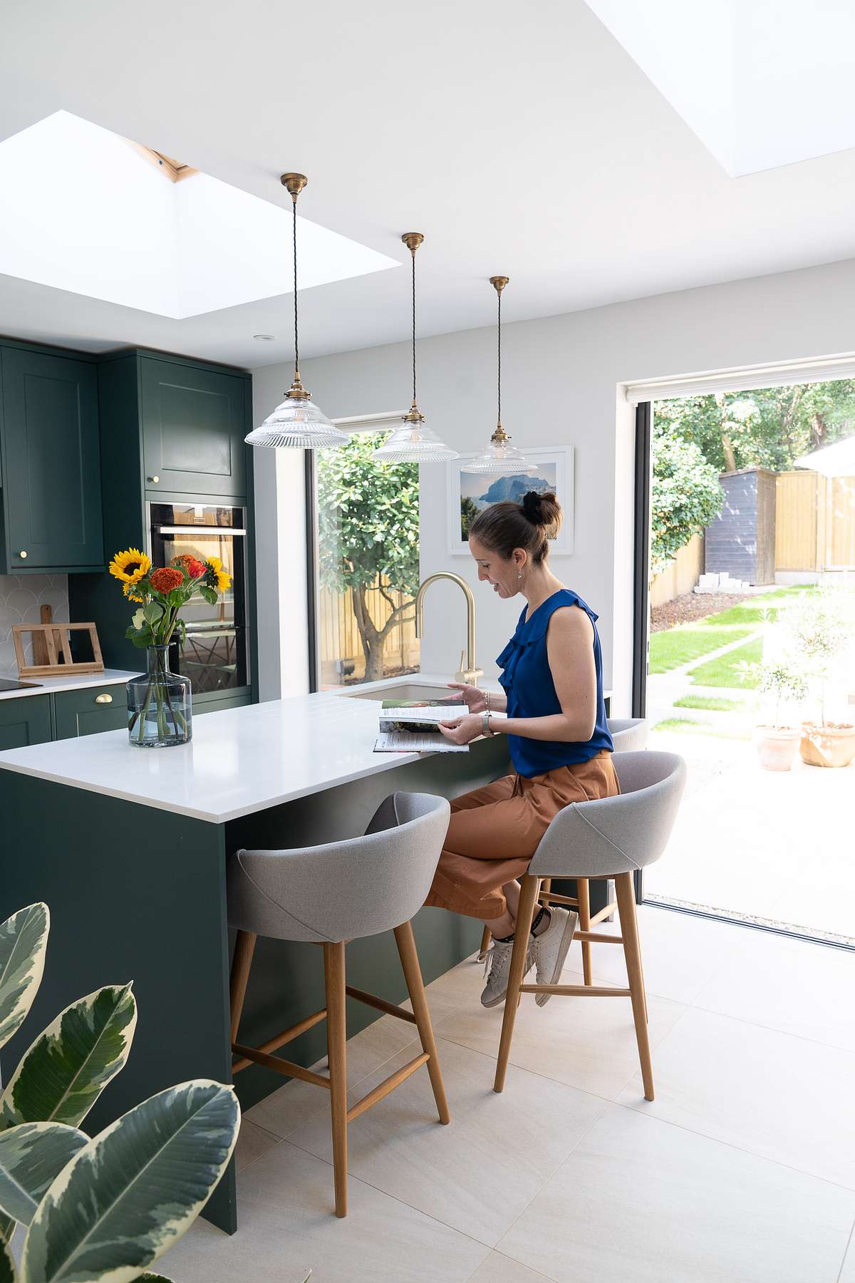 kitchen with breakfast bar and woman looking at magazine