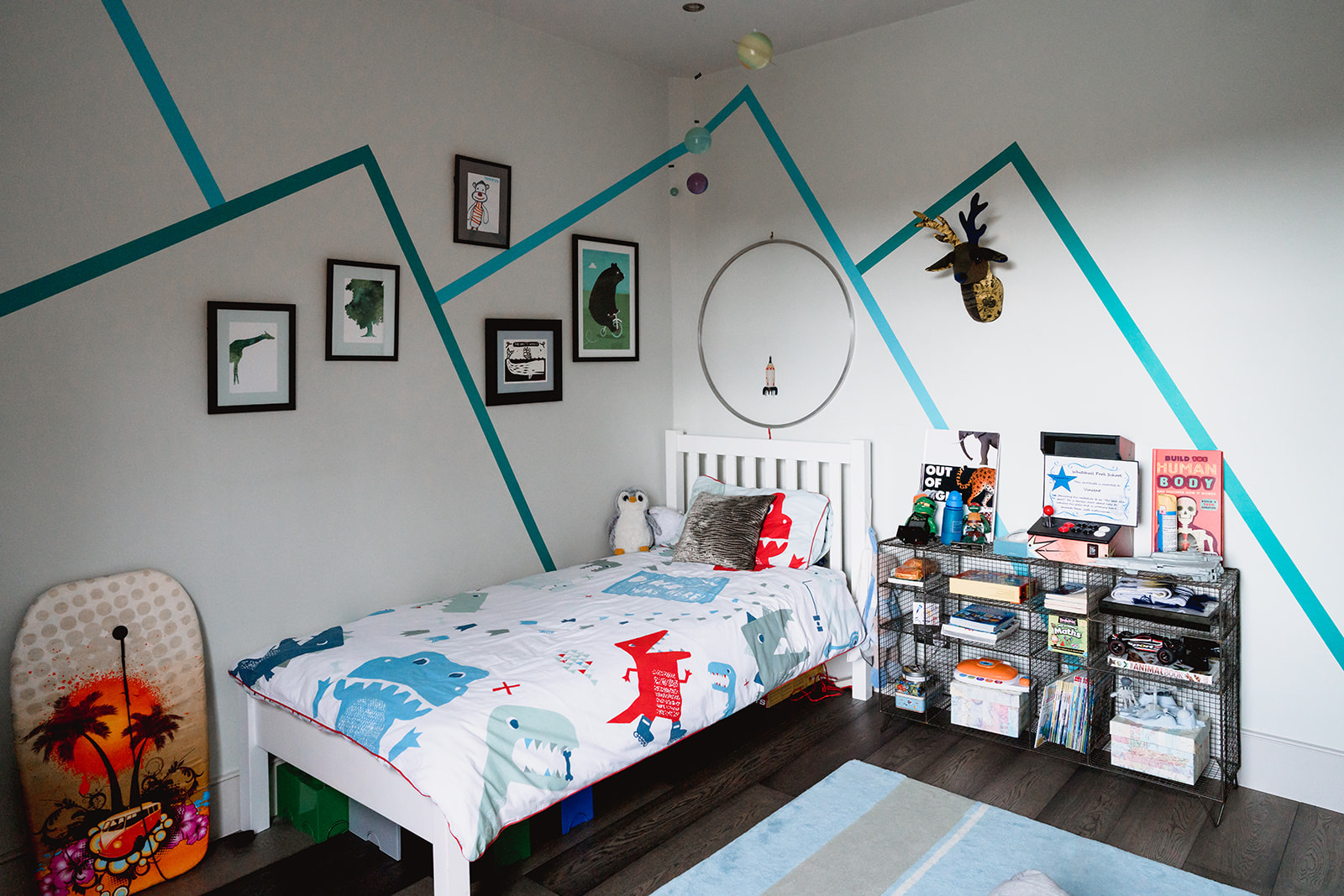 children's bedroom with bed, storage and wall art